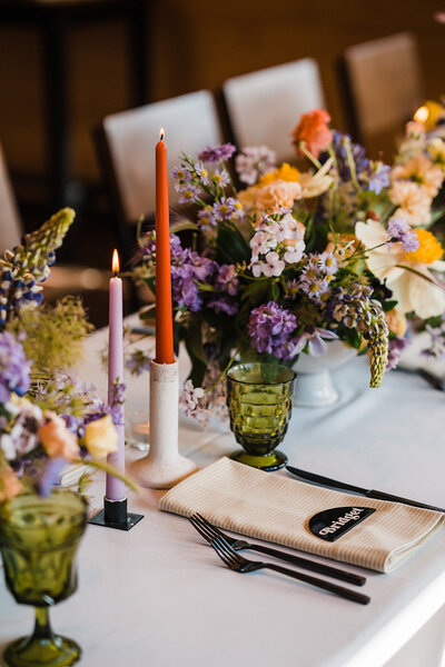 Colorful wedding reception table with colorful flowers and vintage glassware in Alaska