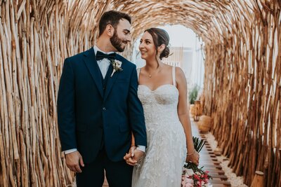 A joyful bride and groom share a loving moment at their destination wedding. This beautiful couple celebrates their big day with the help of expert destination wedding planners. Perfect for illustrating seamless destination wedding planning and luxury travel services.
