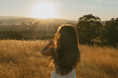 girl standing in wildflower field in Oregon