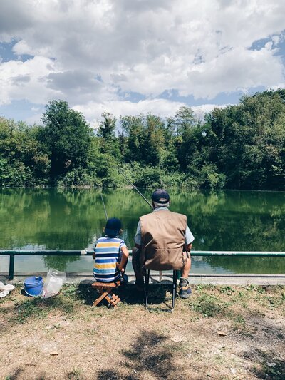 grandpa and grandson fishing at a lake