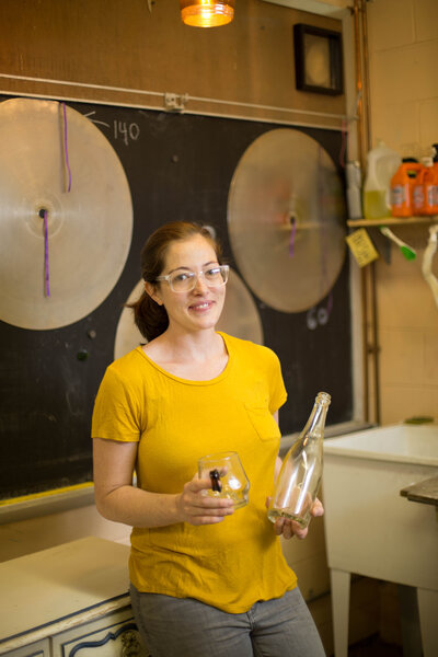 Business owner holding product, hand blown glass