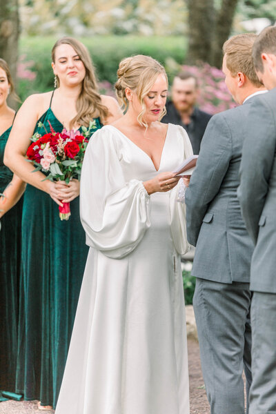 bride and groom exchanging wedding vows during garden wedding ceremony