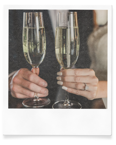 couple holds champaign for engagement photos in las vegas bar