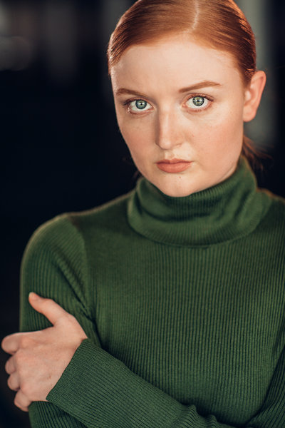 Headshot of red head female actress in Los Angeles wearing green turtle neck