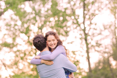 A couple shares a romantic kiss in the woods of Black Rock for a fall engagement session