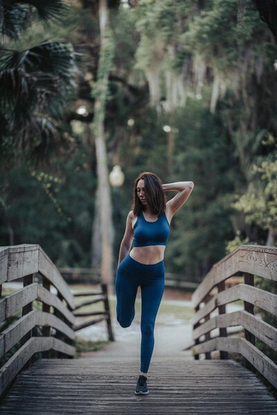 Woman Stretching On Running Trail