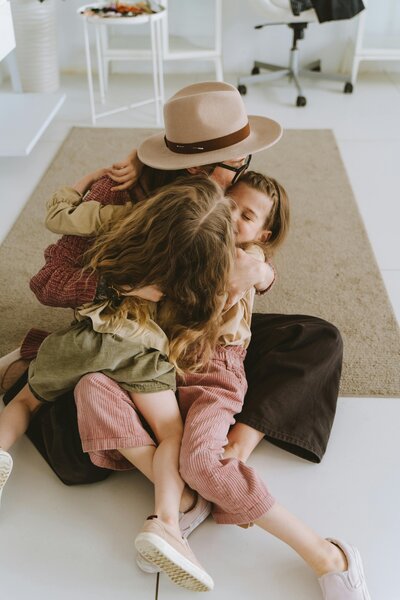 mom hugging kids