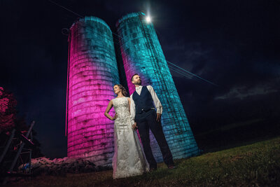 Wedding couple posing for wedding photos on a farm.