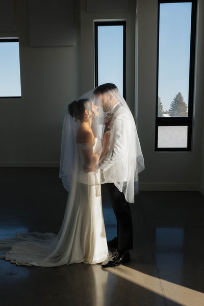 Couple touching foreheads and looking into each others eyes after their wedding ceremony at a hotel wedding in Minnesota