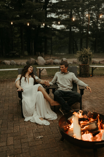 bride and groom kissing with guests holding sparklers in the background at Stone Prairie in Brillion WI