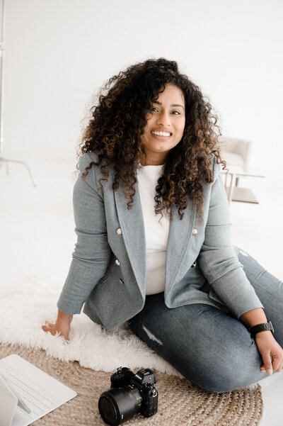 woman sitting on the floor while smiling