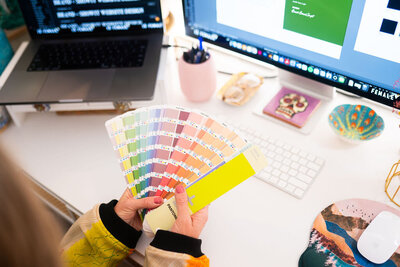 Designer picking colors for a brand - Create & Wander