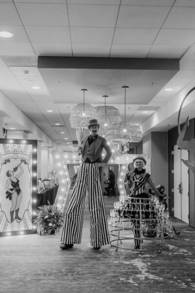 Black and white image of circus entertainers at a party planned by Fancy Chancey in San Diego CA