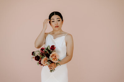 woman holding bouquet during wedding portraits