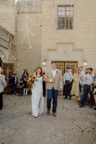bride wears grooms cowboy hat at their ranch wedding