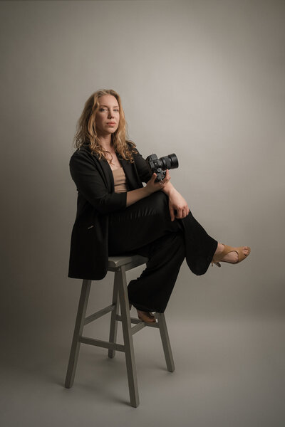 LaScho Studio portrait on stool holding camera