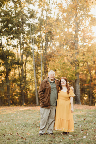 Photographer in Blacksburg, Virginia, Melena Lawson and her husband standing in a field. 