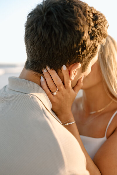 Couple kissing at sunset during a romantic Folly Beach engagement session in Charleston, SC.