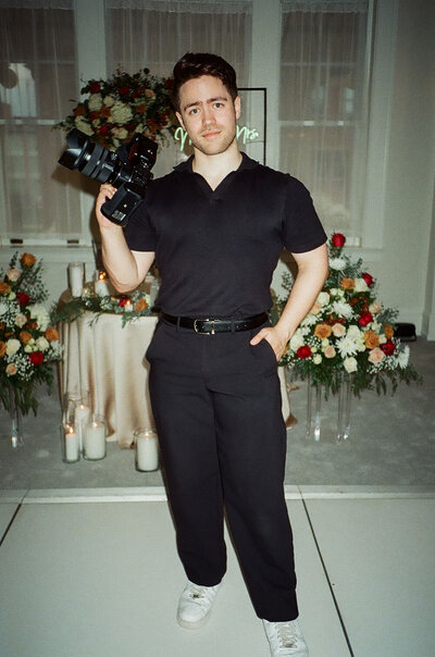 Portrait of NYC wedding and elopement photographer Dom Augustine in action during a wedding day.