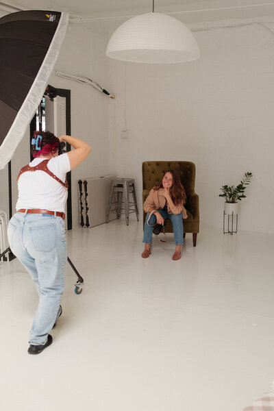 Laura photographs a client in a studio