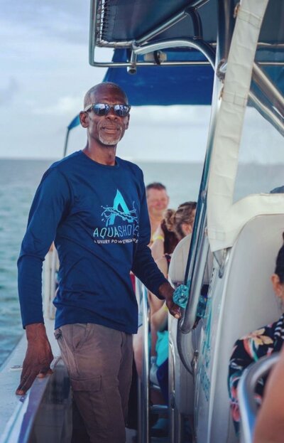 An Aqua Shores Captain manning a powerboat