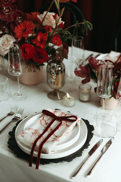 Pink floral arrangement in front of a white wall