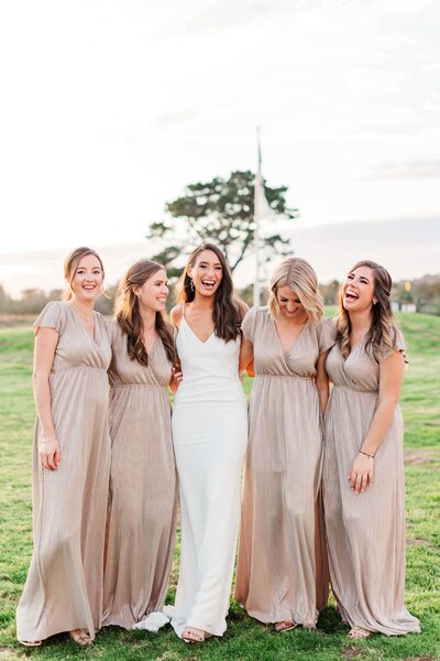 bride-with-bridesmaids-at-sunset