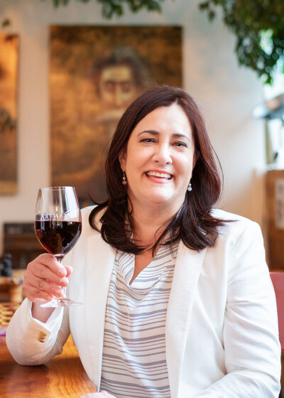 Event coordinator enjoying a glass of wine in a tasting room