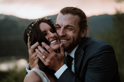 Joyful couple embracing at sunset, documented by Breckenridge wedding and elopement photographer and videographer.