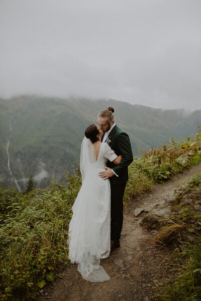 Couple stands on a trail in Juneau, Alaska during their elopement