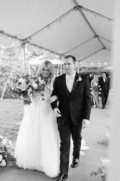 wedding couple walking down asile at their backyard wedding in mason, ohio