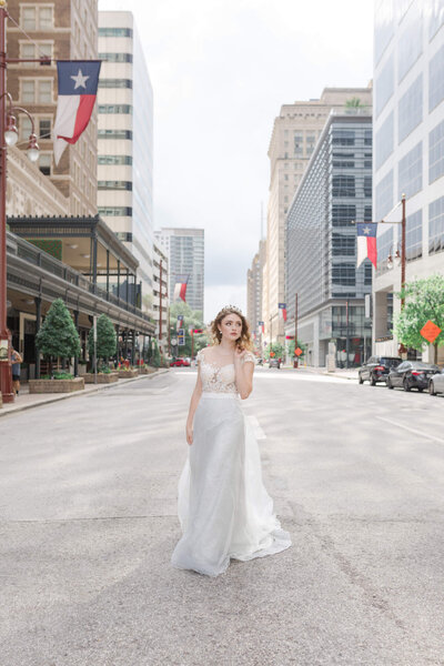 model walks down street in downtown Houston by Swish and Click Photography