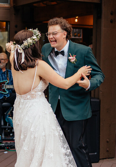 first dance as bride and groom with groom laughing