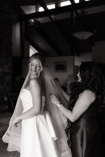 Candid mother-daughter moment during getting ready at Idaho wedding venue