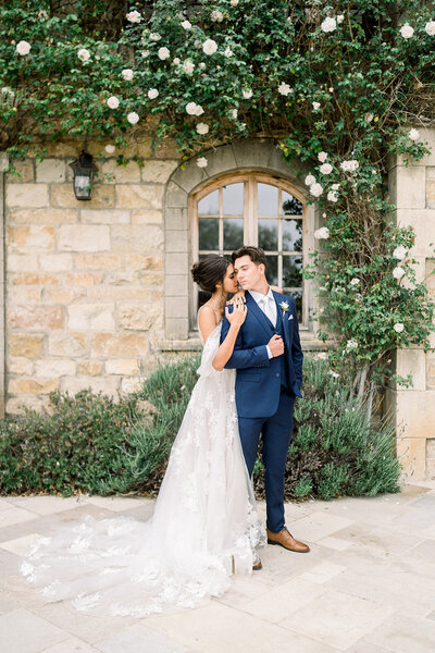 A stunning wedding ceremony at Stanford Memorial Church in California, with the bride and groom sharing a romantic moment, captured by Tiffany Longeway Photography.