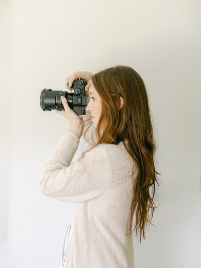 Side profile of Oregon Wedding Photographer Heather, of Among The Oaks, holding a camera to her eye
