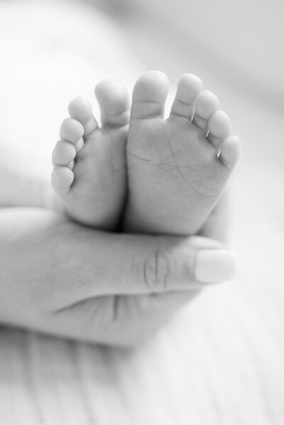 baby feet on mom's hand