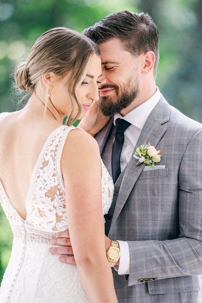 Capture the tender moment of a bride and groom holding each other close during their portrait shoot at a historic estate. A perfect expression of their love and connection on their special day.