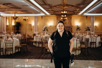 Alexa Nahas standing in soft natural light, during a wedding shoot in Philadelphia.