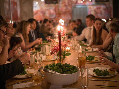Glowy photo of people sitting at a candlelit table