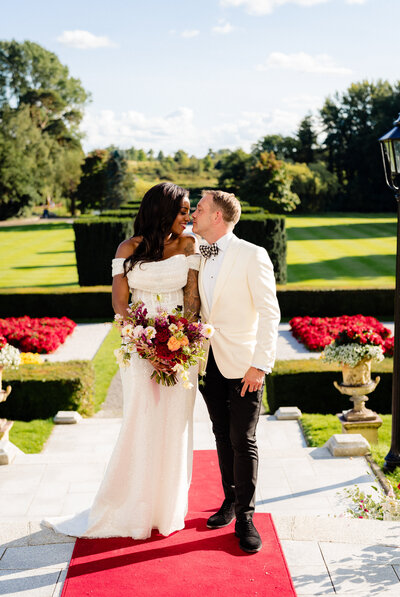 Bride and groom walking on a red carpet at The K Club in Kildare, Ireland 