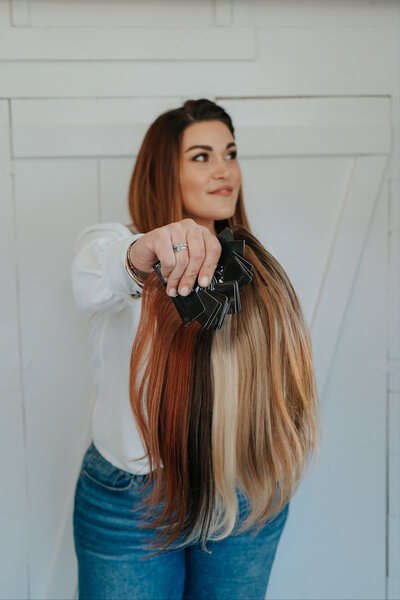 Hairstylist holding ISLA Hand tied hair swatches