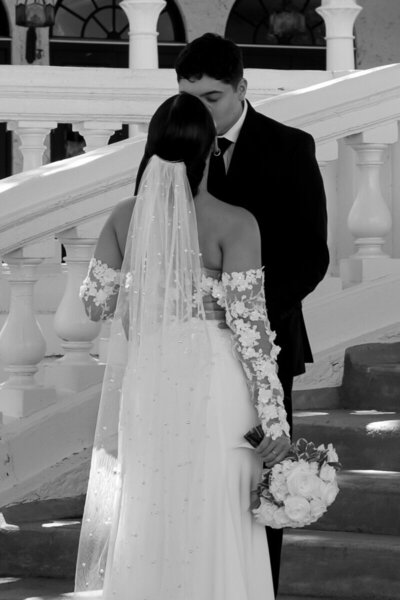 Romantic kiss between bride and groom on elegant steps. Wedding photography in Tampa
captured by Priscila Del Cristo.
