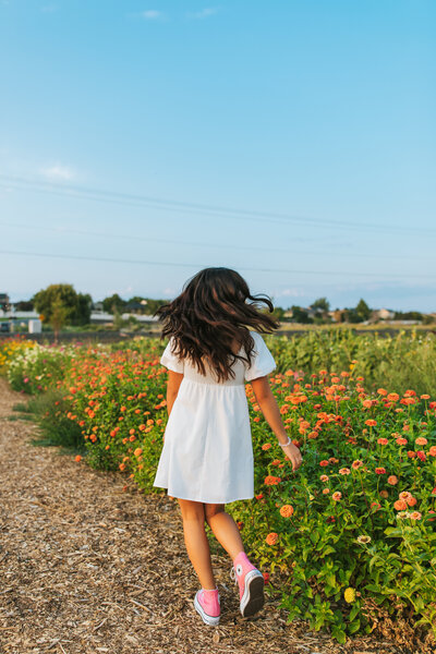 Girl twirling in sunlit field Washington State senior session