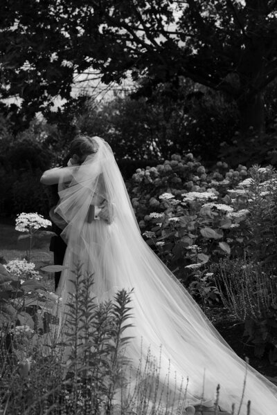 A couple embraces during their first look at the Inn at Fernbrook Farms in Pennsylvania