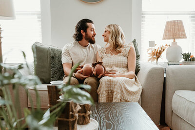 Charlotte family photographer capturing a cozy lifestyle newborn session with parents in love with their twins at home.