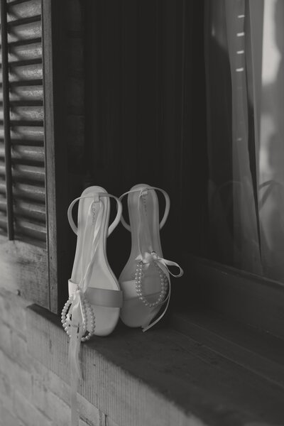 black and white photo of brides heels
