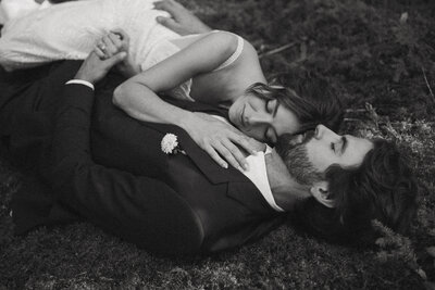 Wedding couple lying in the grass.