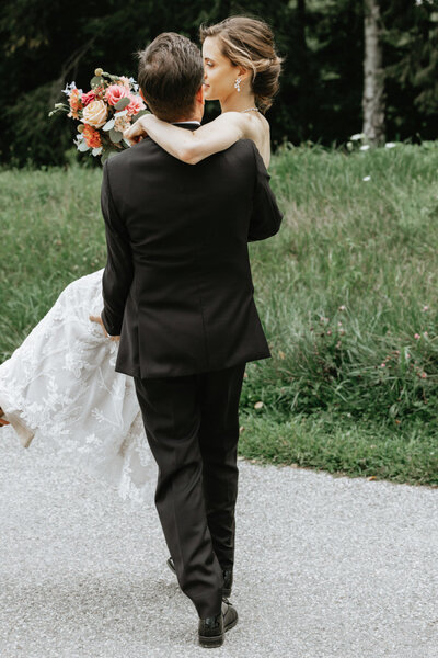 Groom carrying bride, Berkshire Wedding at Buxton School