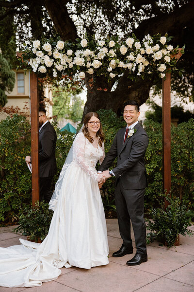 bride and groom smiling at outdoor Maxwell House wedding ceremony
